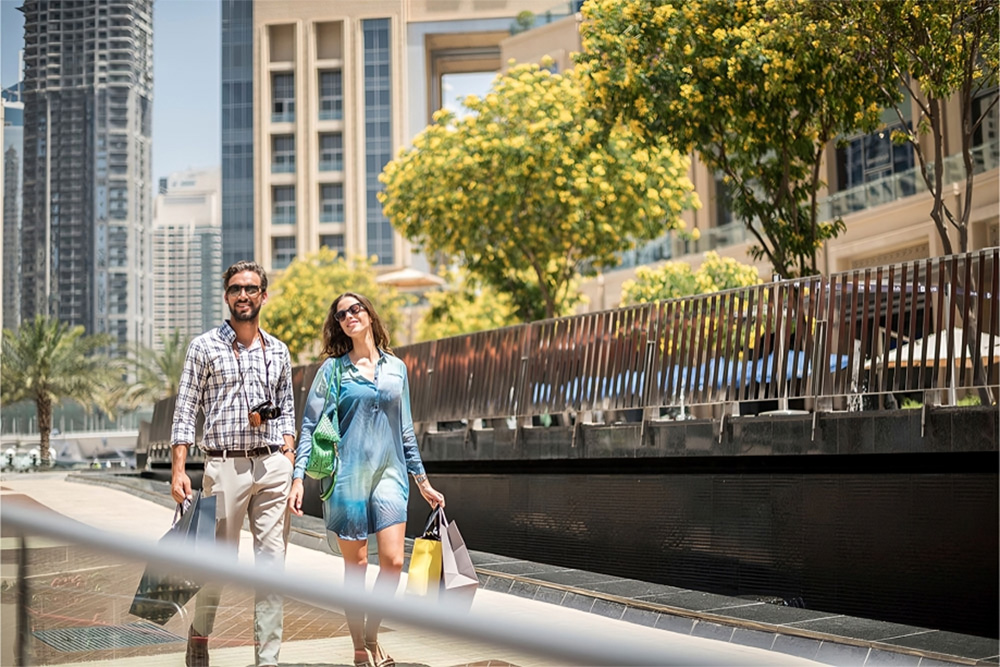 Couple on the walkway returning from shopping