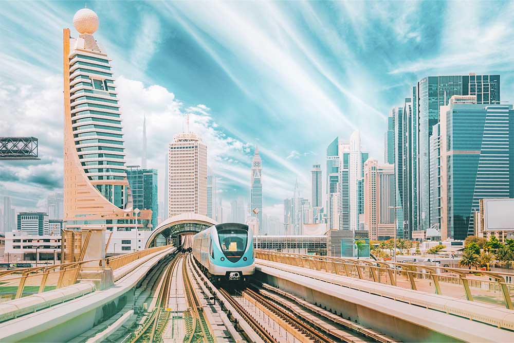 Monorail Subway train rides among glass skyscrapers in Dubai