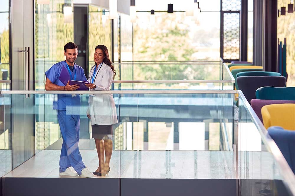 Medical Staff In White Coat And Scrubs 