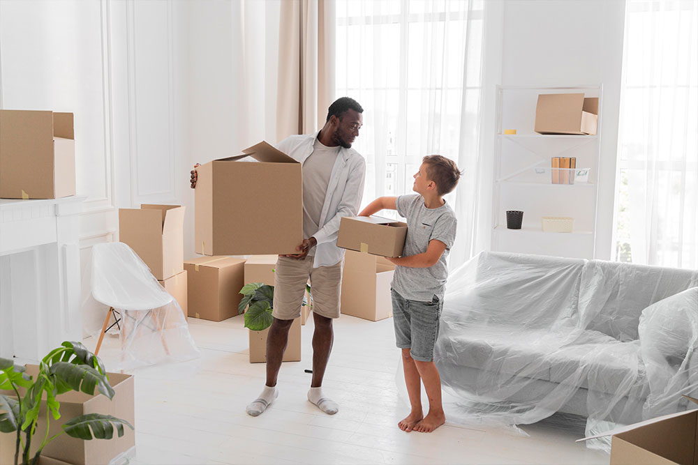  a man and a child holding big boxes