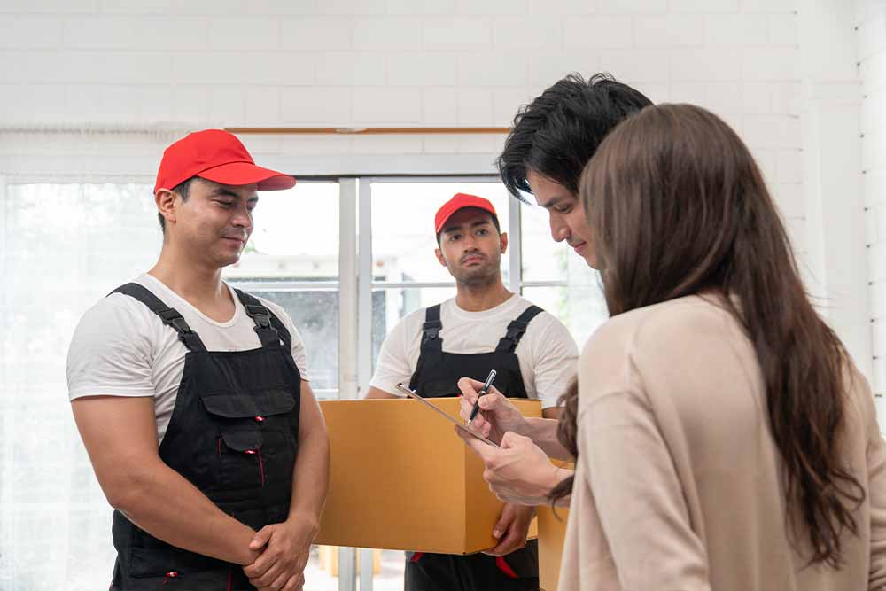 Staff of movers company working with relocating clients