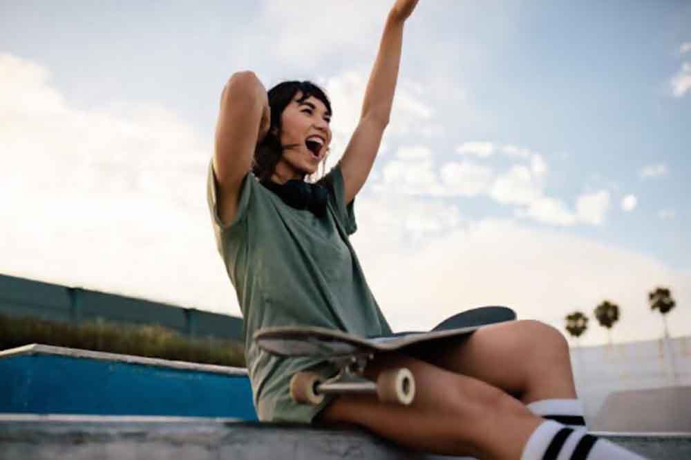 Girl sitting with a skateboard