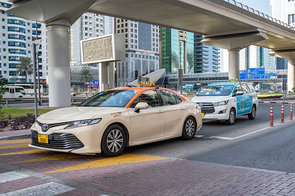 Image of Dubai taxis under the bridge