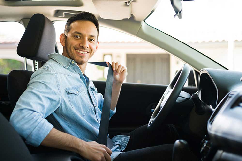 A man tying his seatbelt