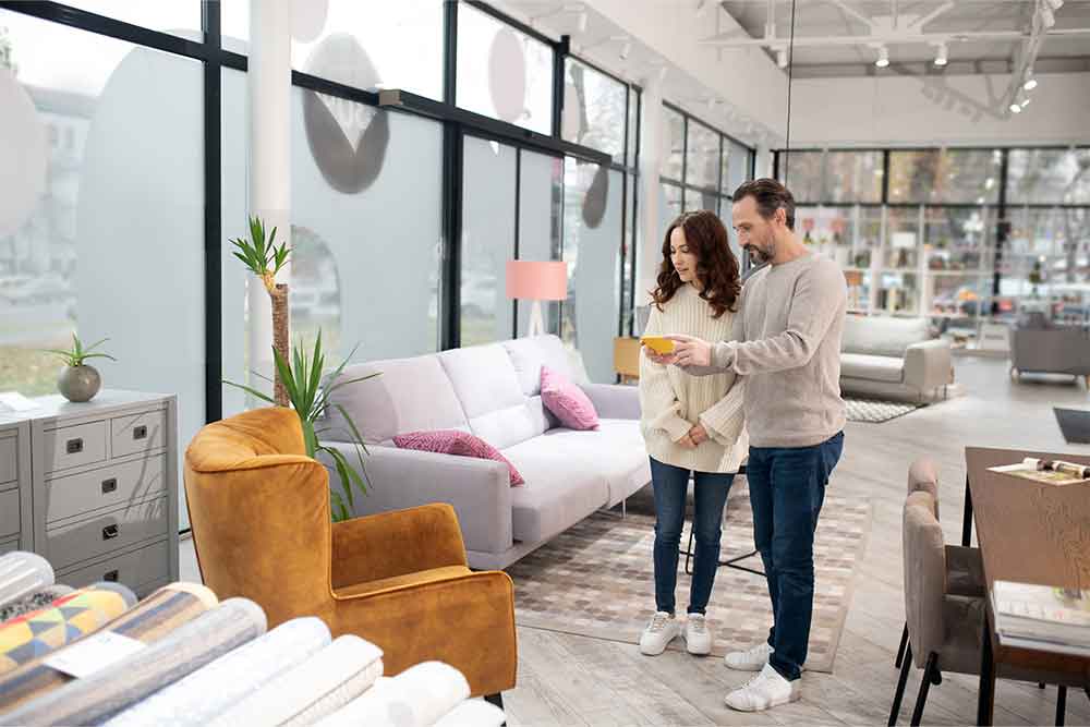 Couple roaming in furniture shop 