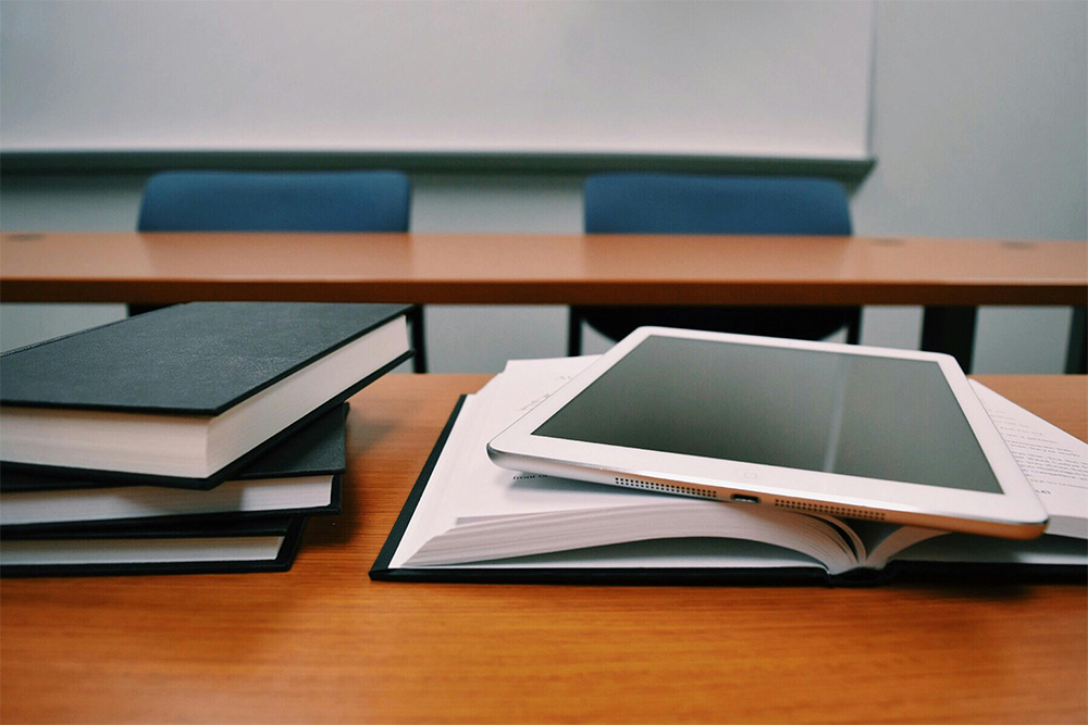 school books stacked on a table