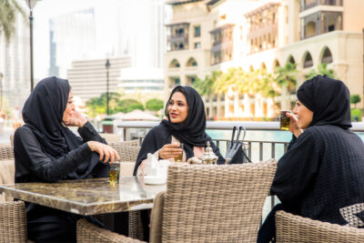 Arabic women with abaya bonding and having fun outdoors