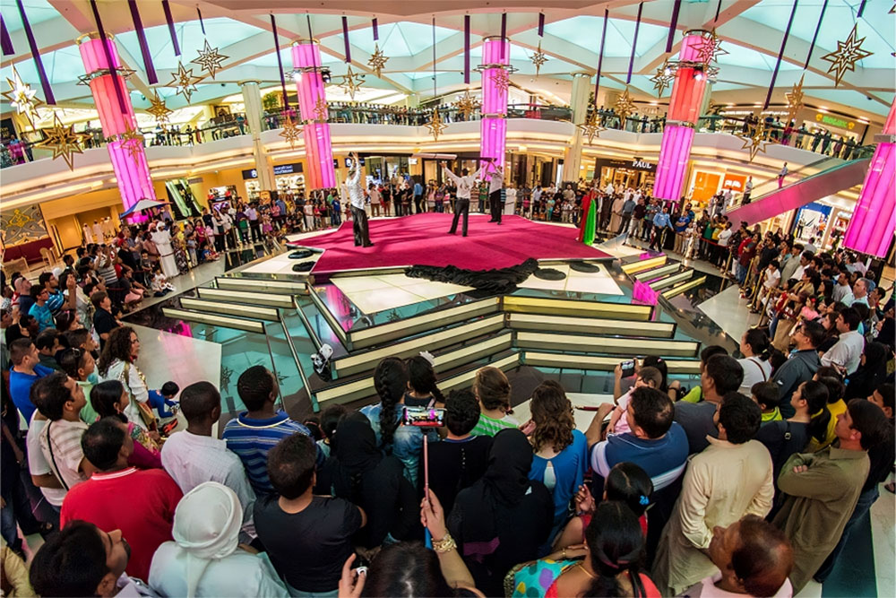 A man performing on stage at the mall