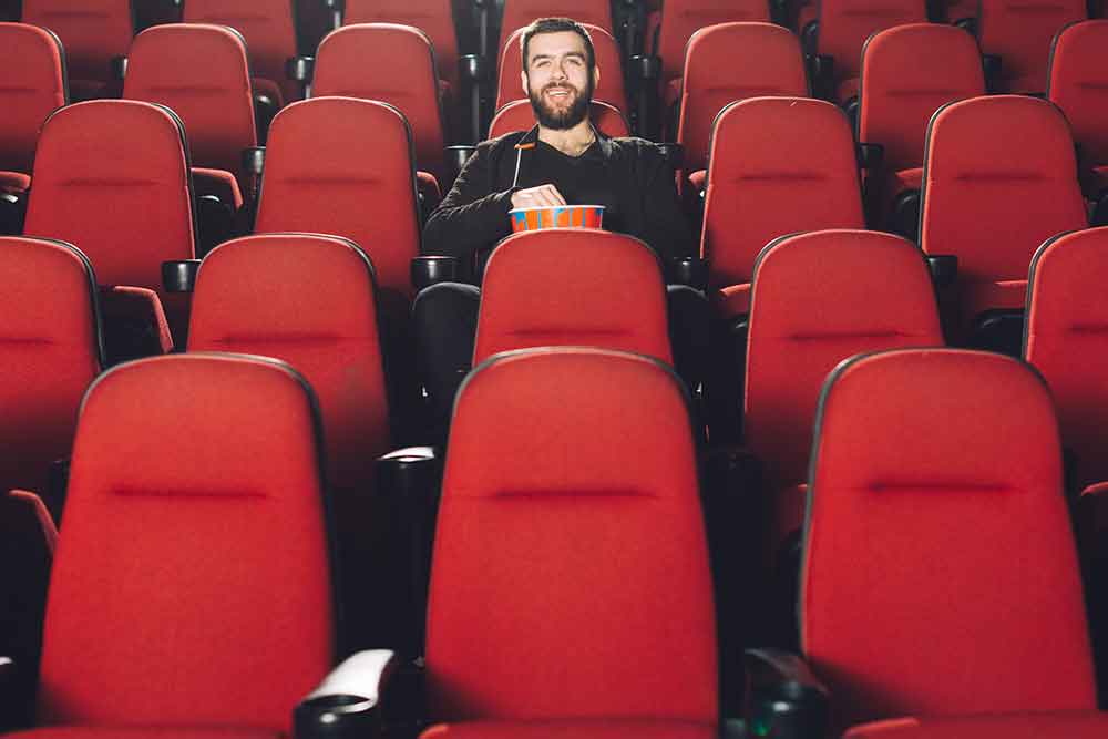 a man in a cinema with popcorn