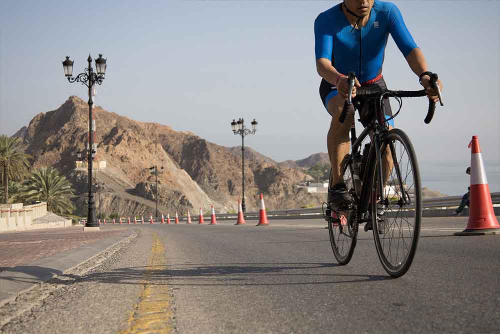 a person cycling on track in dubai