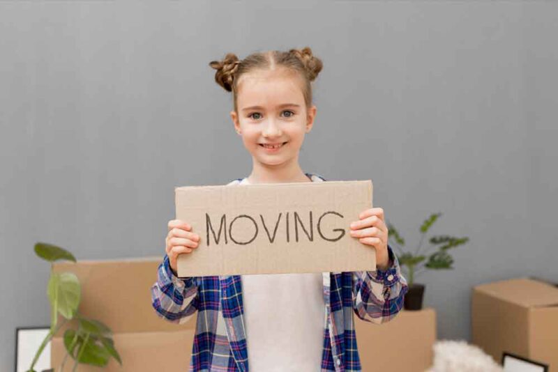 a children with a moving board and boxes in the background