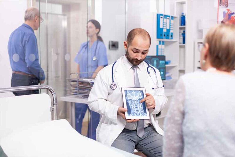 a doctor showing body report covered by medical insurance