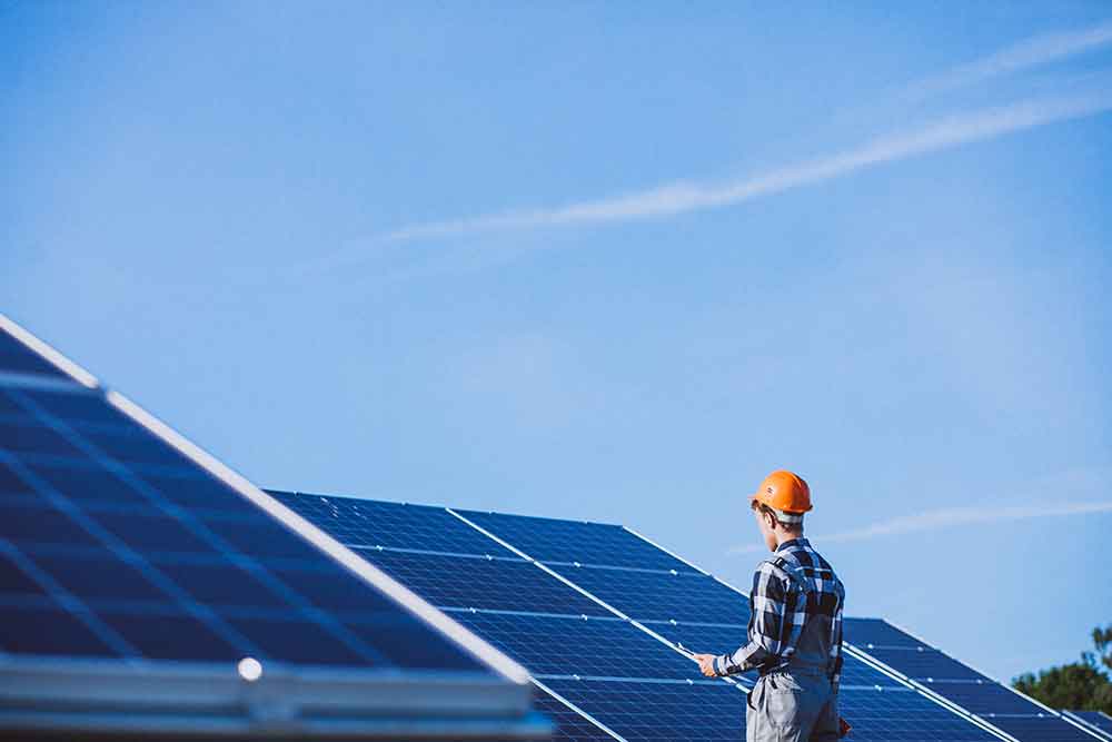 worker installing solar panels