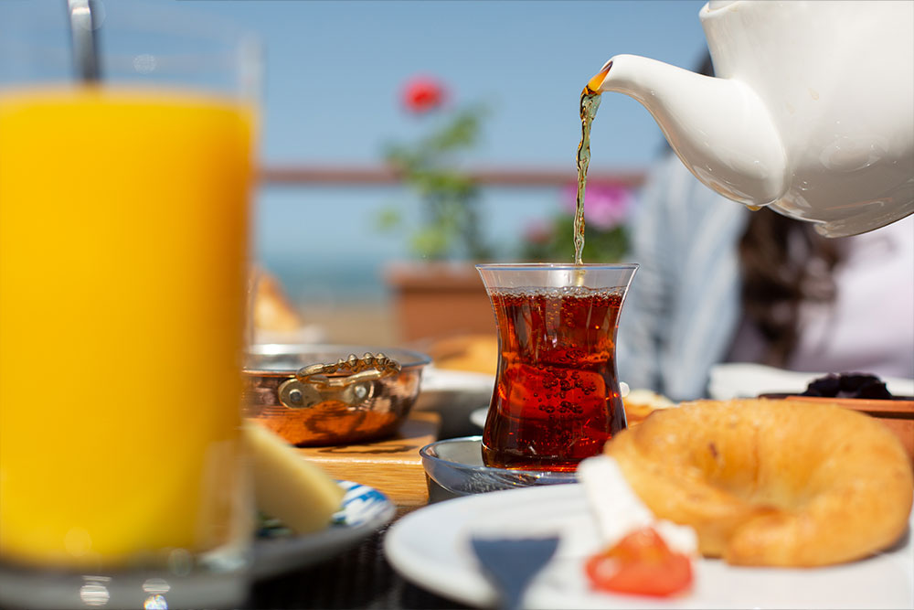 Pouring black tea at high tea places in dubai