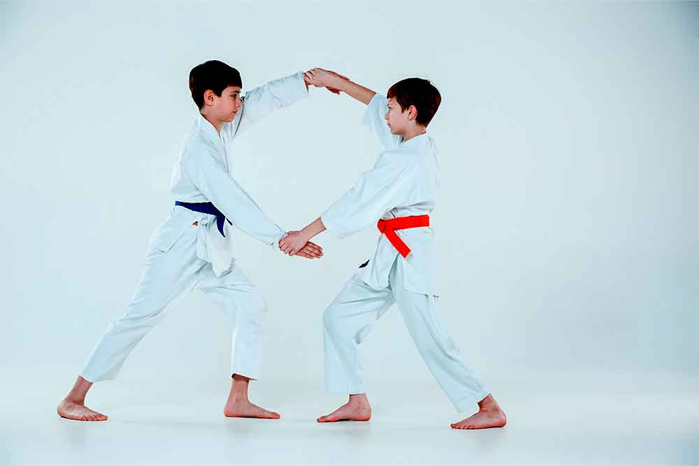 Young kids in a white karate uniform practising karate class in Abu Dhabi