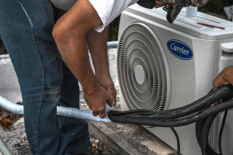 Man Taping a Hose