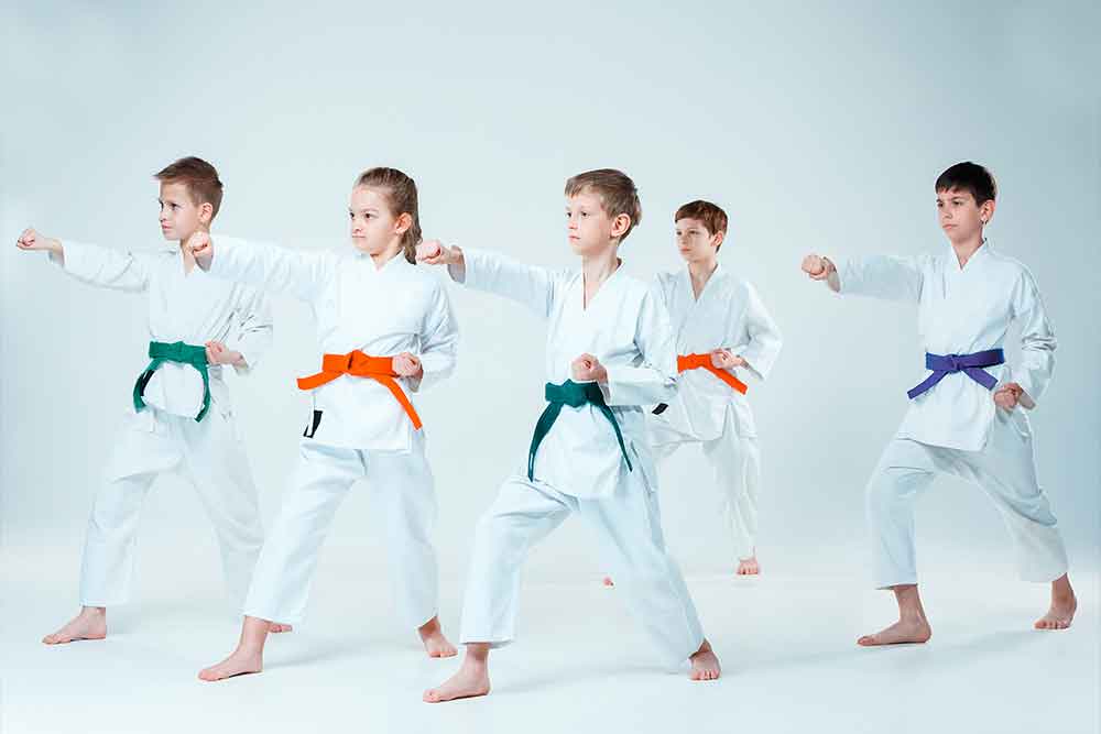 Group of karate students in Abu Dhabi performing a synchronised karate actions