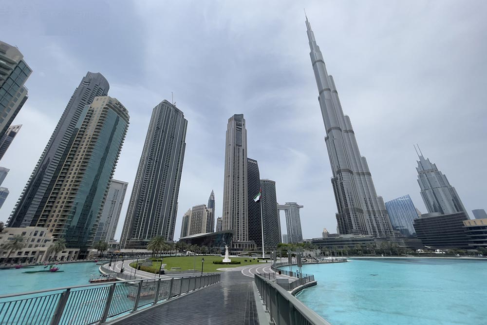 Dubai city building with corniche view under blue sky. 