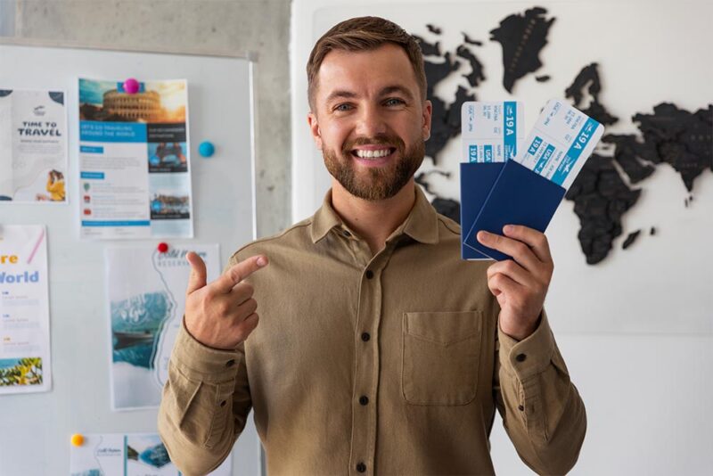 a man holding passport and tickets