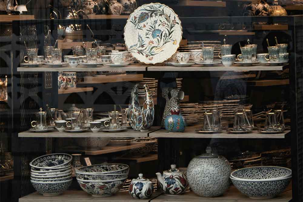 Different styles of crockery items decorated in a souvenir shop in Dubai.