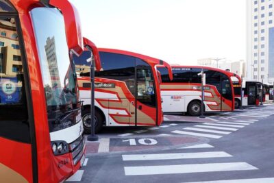 Red and white buses standing on a bus station