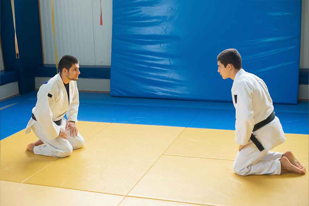 Interior of a karate dojo in Abu Dhabi, with student practising karate moves in white uniforms