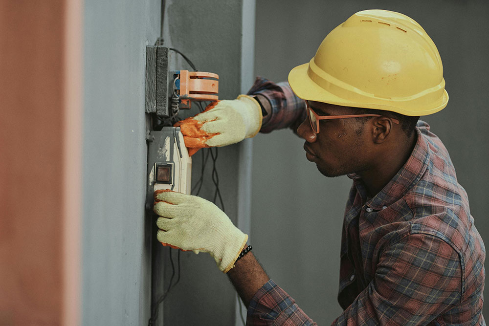 Home maintenance technician working on electrical connections