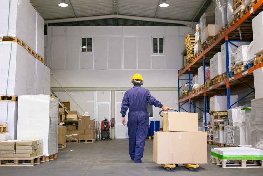 Worker aligning carton