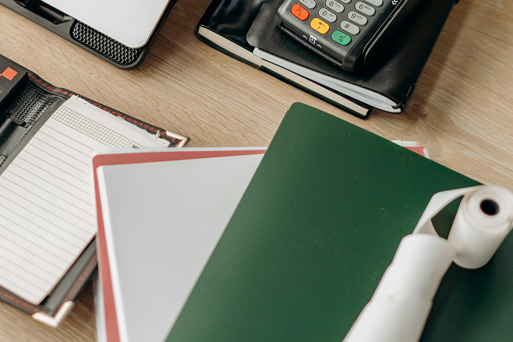 An image of an office table with files, calculator and folders 