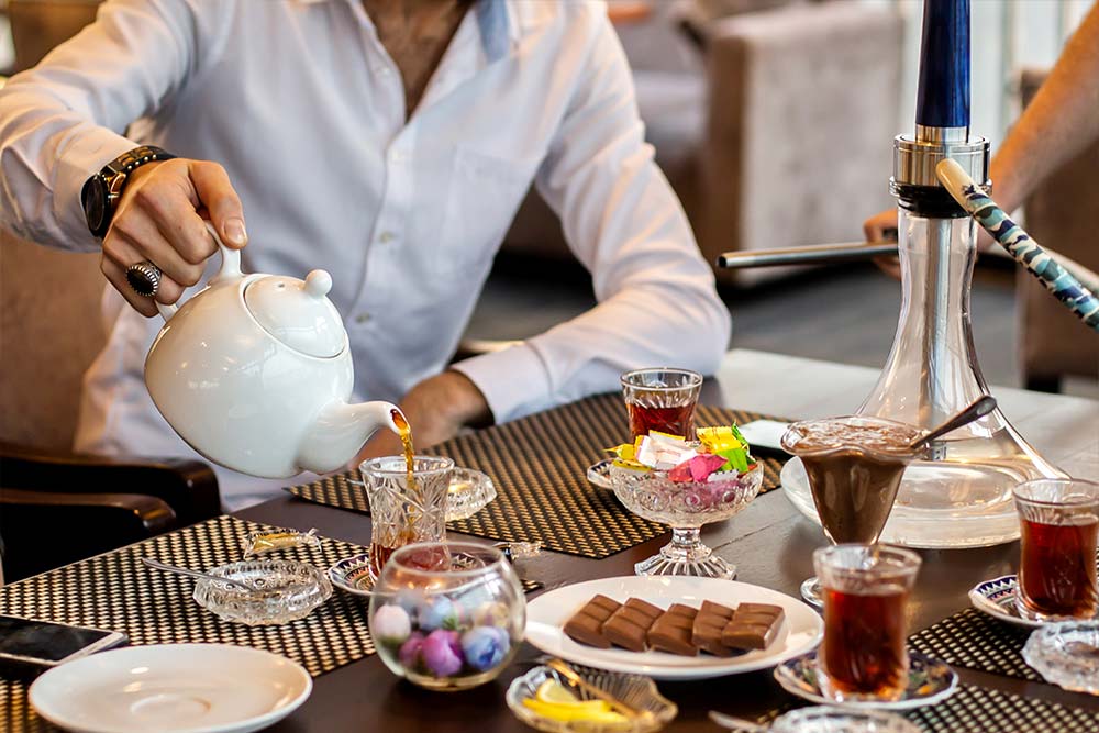 Serving kehwa at the high tea places in dubai