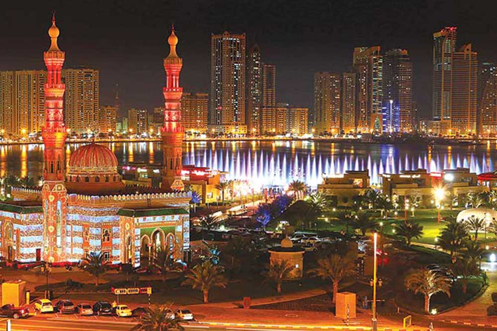 picture of a mosque with a lake view at night time,
