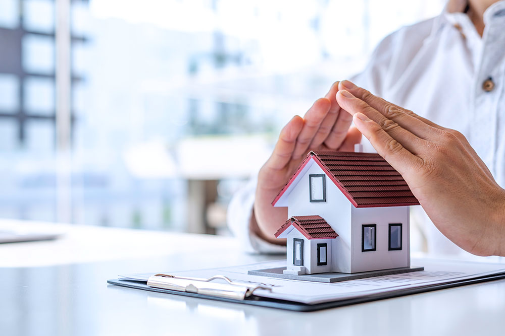 A person covering ahouse souvenir with his hands