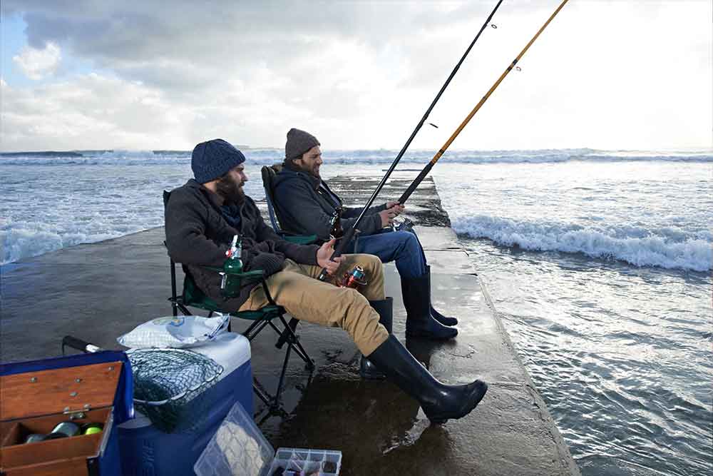 Friends enjoying fishing in a fishing spot in Dubai