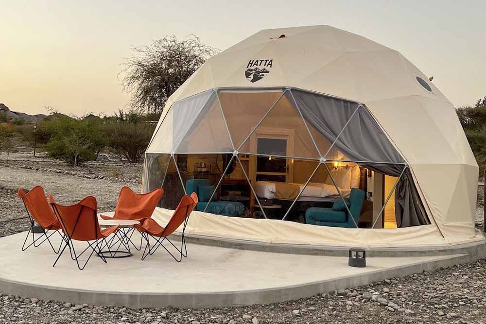 An image of a camp with four red chairs