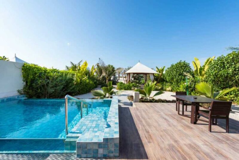 A luxurious view of a pool and sitting area 