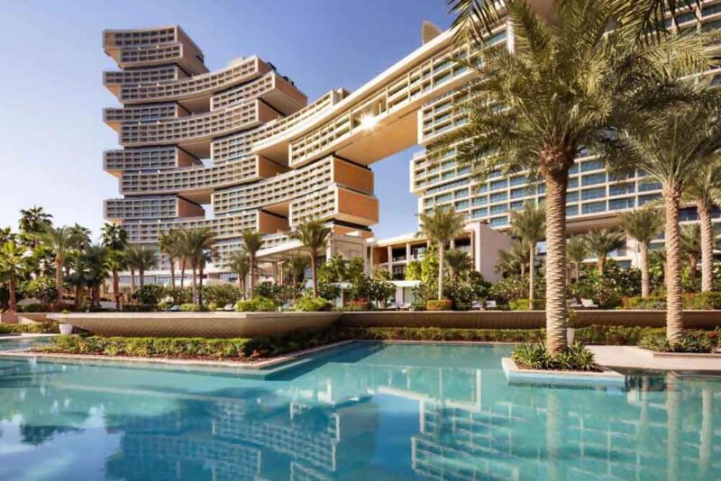 A pool-facing building in Dubai with palm trees