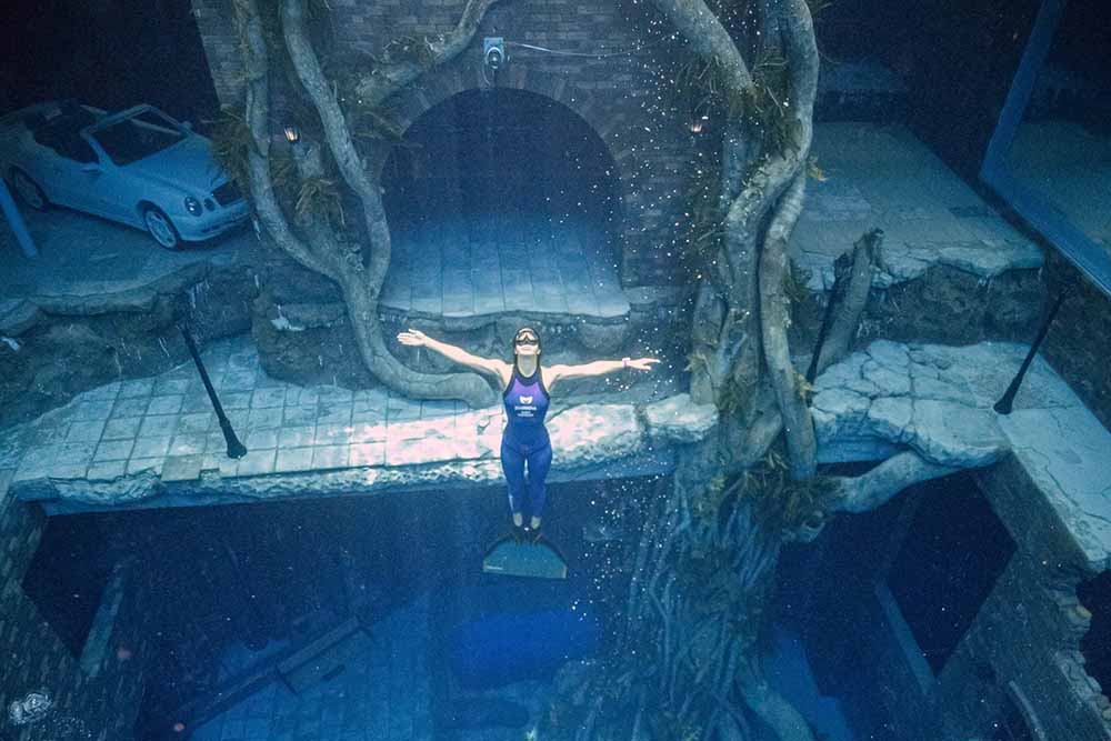 A woman swimming in a deep dive, Dubai