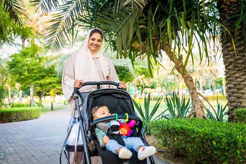  Women with her child in a park 