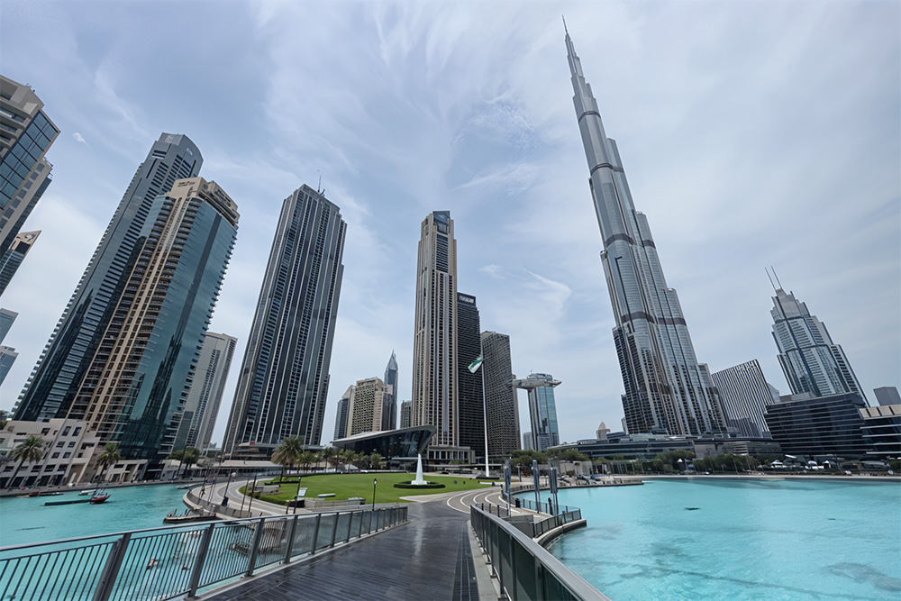 Dubai city building with corniche view under blue sky. 