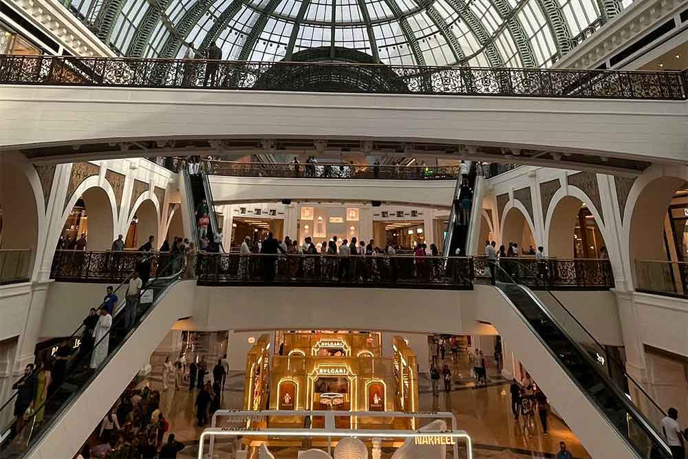 An interior view of a mall in Dubai with several souvenir shops.