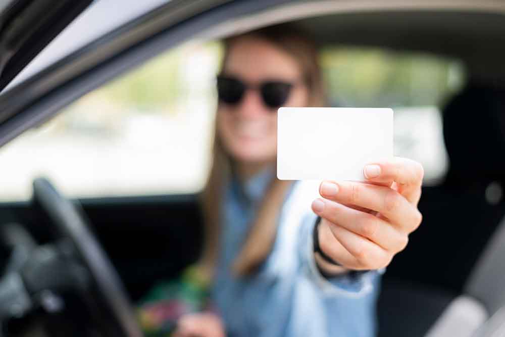 A woman showing her driving licence in fujaira