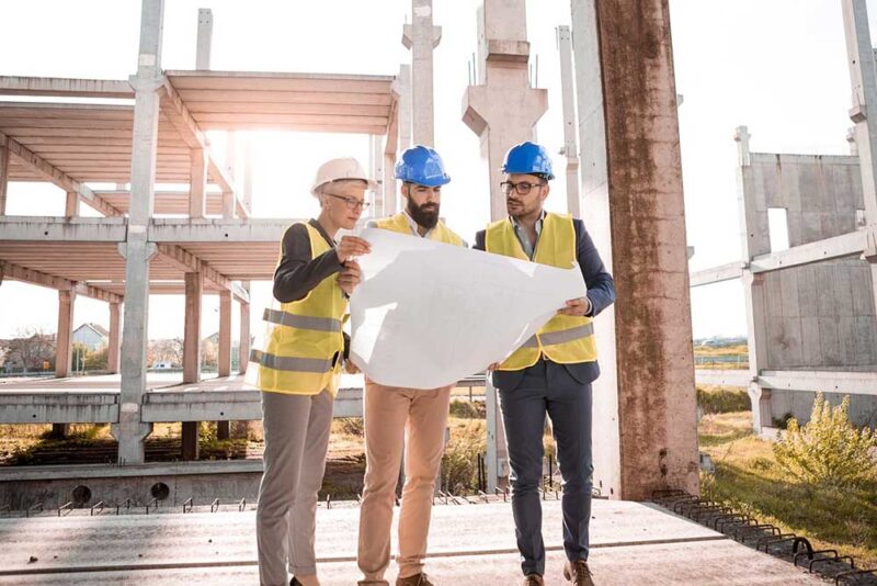 Engineers checking the masterplan of the under construction property