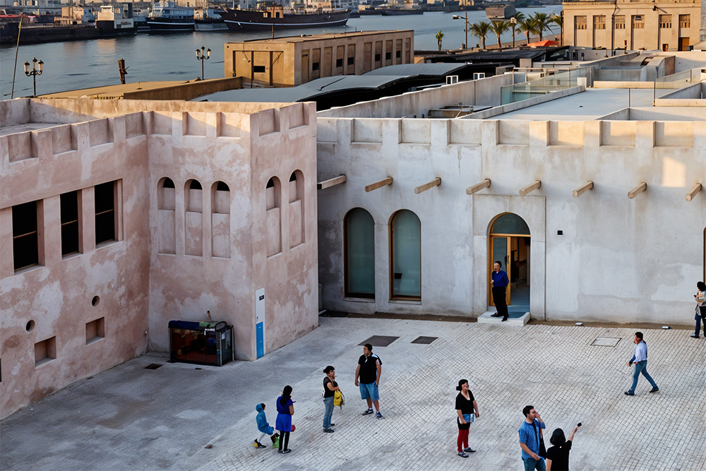 Image of people walking in an old fort-like museum 