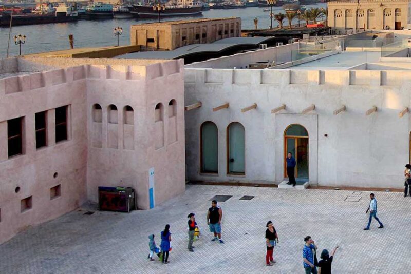 Image of people walking in an old fort-like museum 