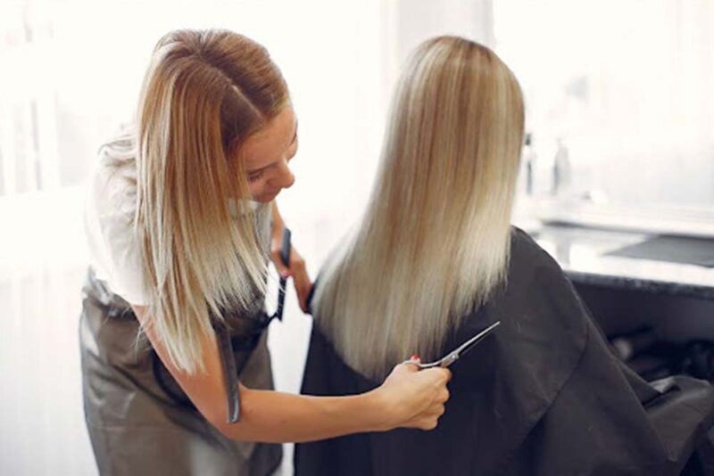 Client getting a haircut at a popular Dubai hair salon