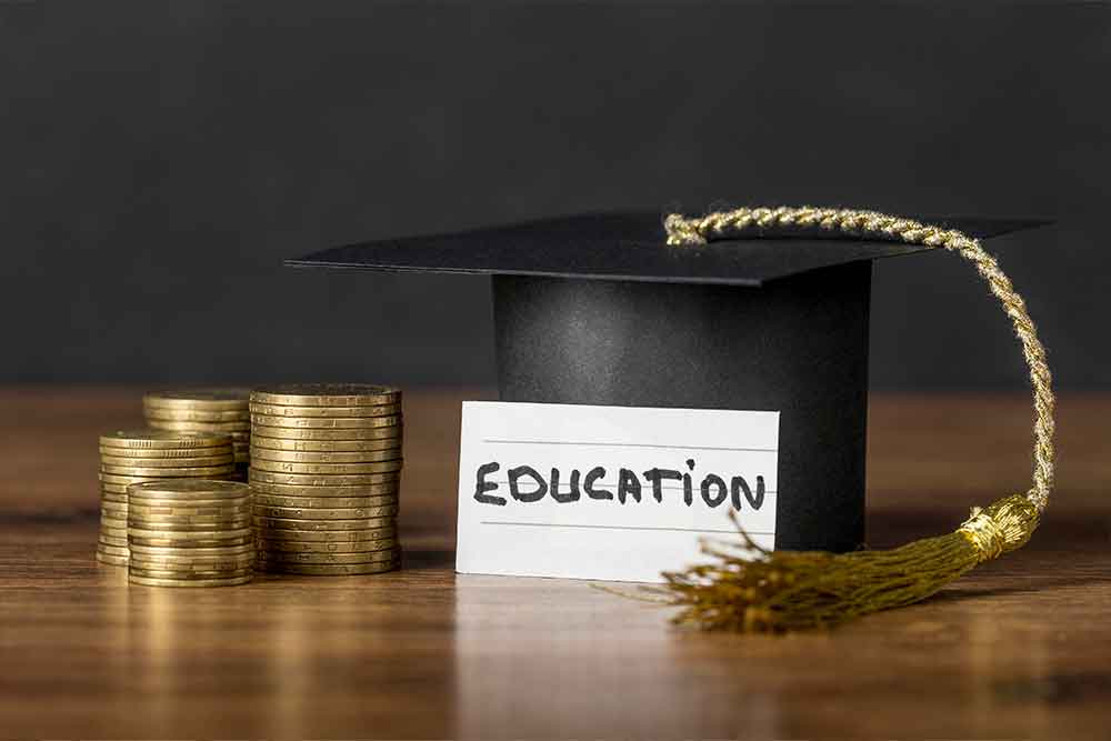 Convocation hat with gold coins on a table 