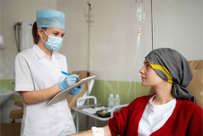 Nurse taking record of patient 