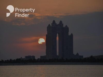 A sea facing high rise in a sunset sky