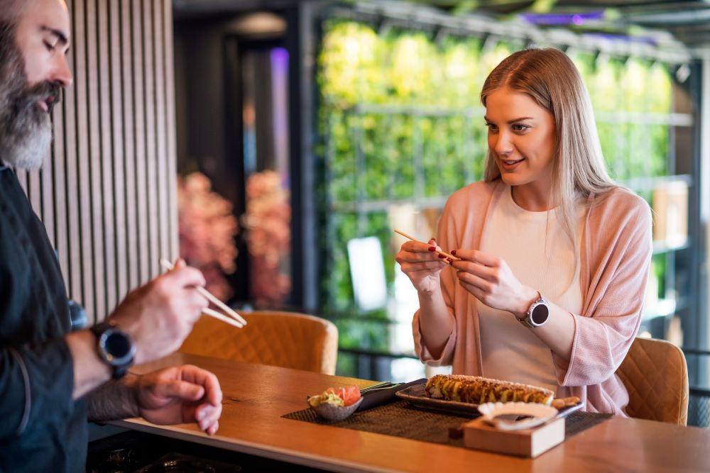 woman eating sushi at japanese restaurant in dubai