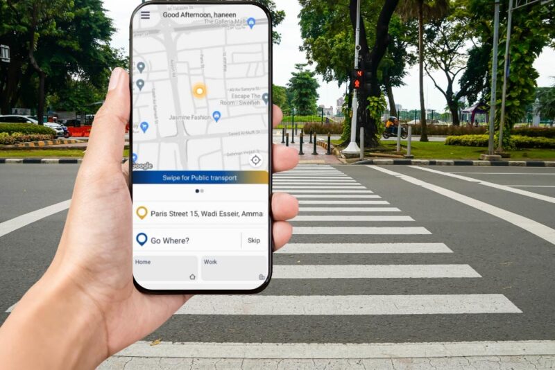 A person using his phone on the zebra crossing 